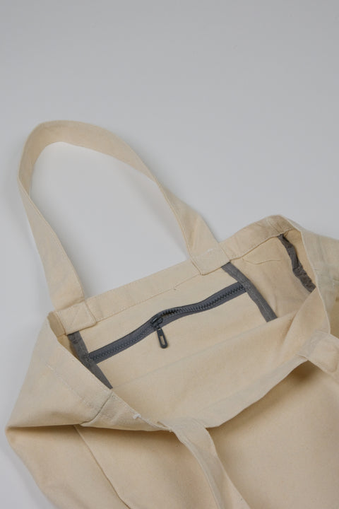 Natural canvas tote with inner zip pocket detail